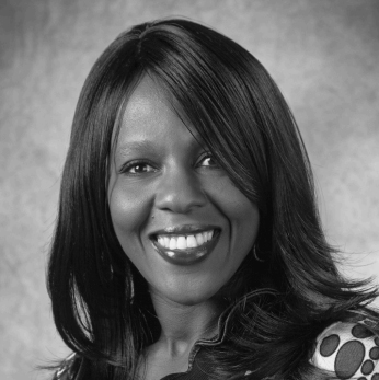 Edna Sader, loan officer and owner of Sader Mortgage, smiling in front of a white background.